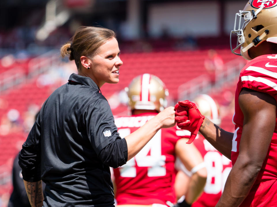 Sep 10, 2017; Santa Clara, CA, USA; San Francisco 49ers seasonal offensive assistant Katie Sowers fist bumps running back Raheem Mostert (31) before the game against the Carolina Panthers at Levi's Stadium. Mandatory Credit: Kelley L Cox-USA TODAY Sports