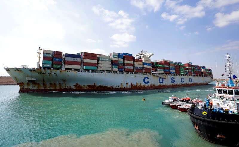 FILE PHOTO: A shipping container of the China Ocean Shipping Company (COSCO) moves through the Suez Canal in Ismailia