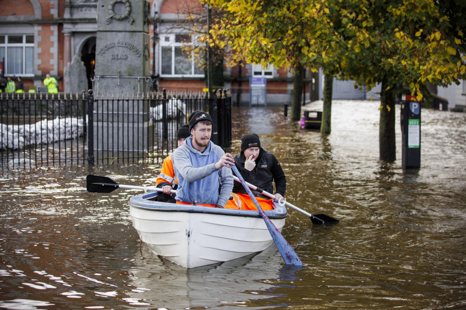 People canoe down a flooded Bank Parade in Newry Town, Co Down, Northern Ireland, Tuesday, Oct. 31, 2023. Flooding was reported in parts of Northern Ireland, with police cautioning people against travelling due to an amber rain warning. (Liam McBurney/PA via AP)