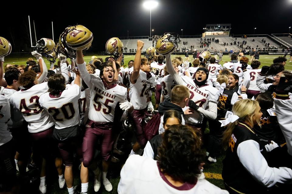 Nov 11, 2022; Westerville, Ohio, USA;  New Albany Eagles players celebrate following their 20-7 win over the Upper Arlington Golden Bears in the Div. I regional semifinal high school football playoff game at Westerville Central. Mandatory Credit: Adam Cairns-The Columbus Dispatch