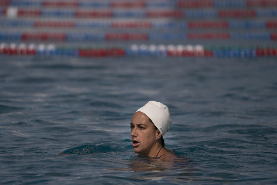 Maggie Steffens, a member of the U.S. women's water polo team, watches as her teammates train at MWR Aquatic Training Center Tuesday, April 27, 2021, in Los Alamitos, Calif. Heading to Tokyo next month, Steffens belongs on the short list of Olympic athletes who just might be the best to ever play their sport. Even if the pride of Danville, California, isn't all that comfortable with that title. (AP Photo/Jae C. Hong)