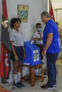 Cuba's President Miguel Diaz Canel casts his vote at a polling station during the new Family Code referendum in Havana, Cuba, Sunday, Sept. 25, 2022. The draft of the new Family Code, which has more than 480 articles, was drawn up by a team of 30 experts, and it is expected to replace the current one that dates from 1975 and has been overtaken by new family structures and social changes. (Jose Manuel Correa, Pool photo via AP)