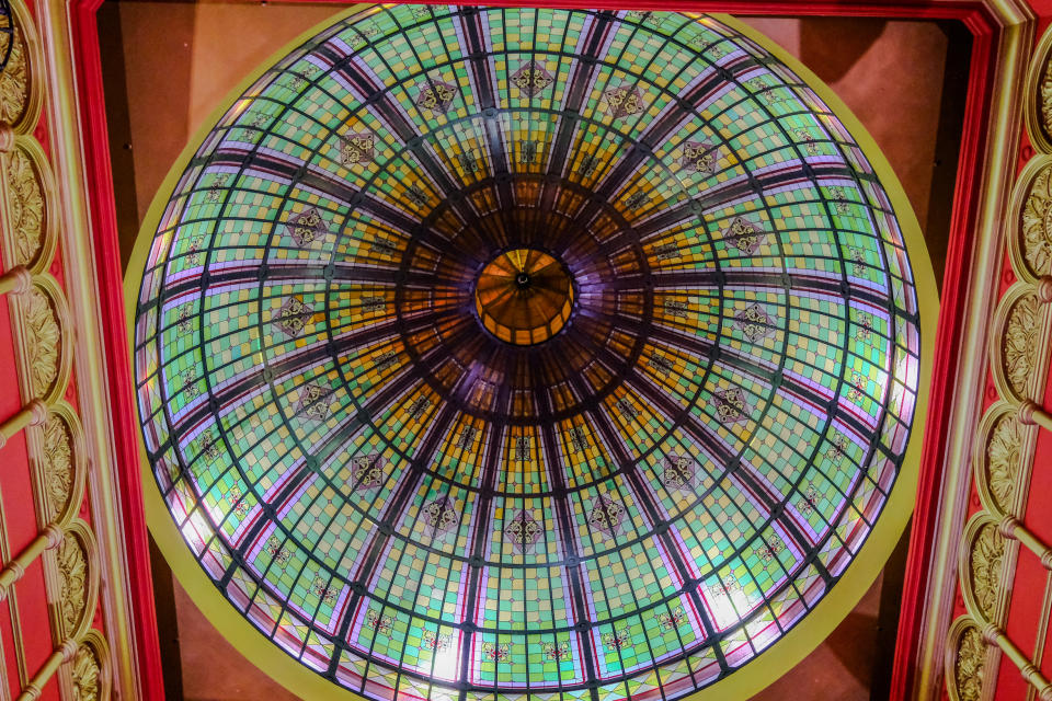 A stained-glass domed roof of a building