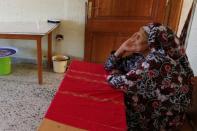 A Libyan displaced Mabrouka al-Twati, 80, who left her home after clashes, is seen in a class room in a school used as a shelter in Abu Slim district in Tripoli