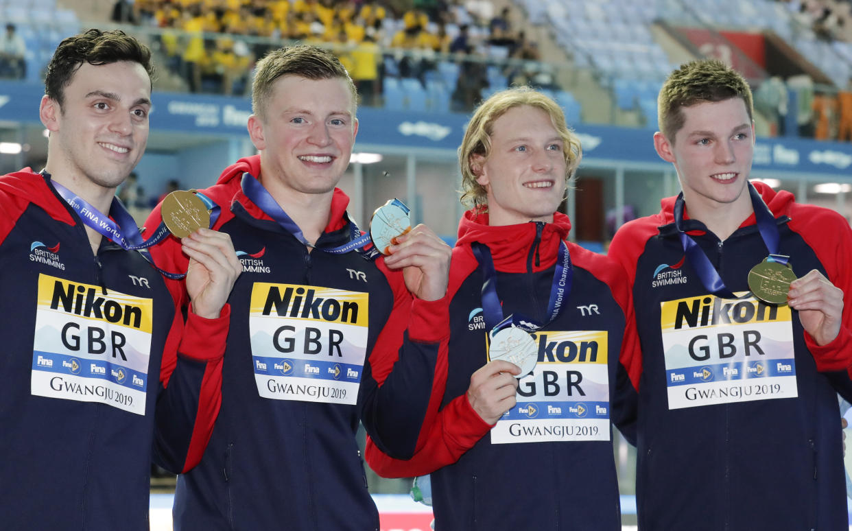 Britain's men's 4x100m medley relay team, from left, Luke Greenbank, Adam Peaty, James Guy and Duncan Scott pose with their gold medals at the World Swimming Championships in Gwangju, South Korea, Sunday, July 28, 2019. (AP Photo/Lee Jin-man)