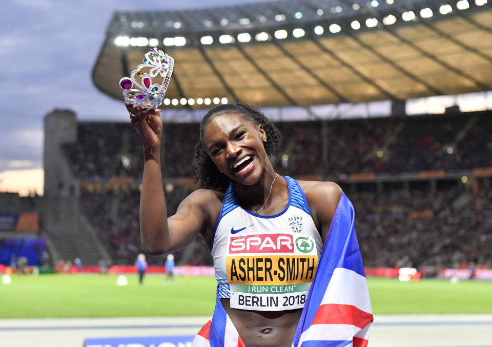 Britain's Dina Asher-Smith wears a diadem when celebrating winning the gold medal in the women's 200-meter final at the European Athletics Championships at the Olympic stadium in Berlin, Germany, Saturday, Aug. 11, 2018. (AP Photo/Martin Meissner)