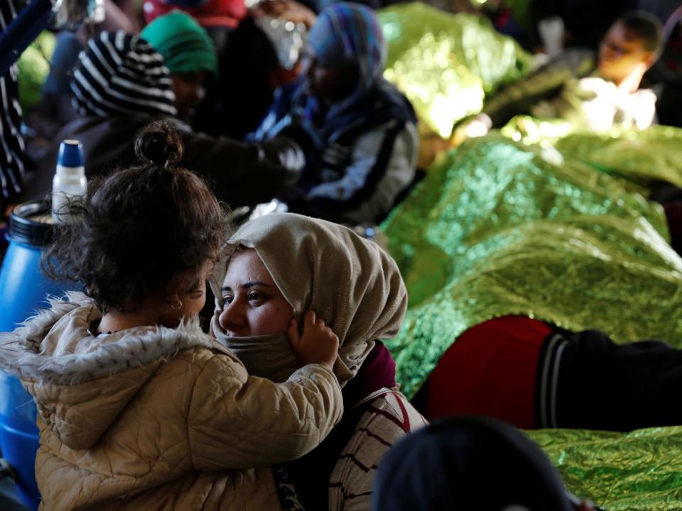 Migrants rest on the Moas ship Phoenix after being rescued off the Libyan coast, as the ship makes its way towards the Italian island of Sicily on 18 April (Reuters)