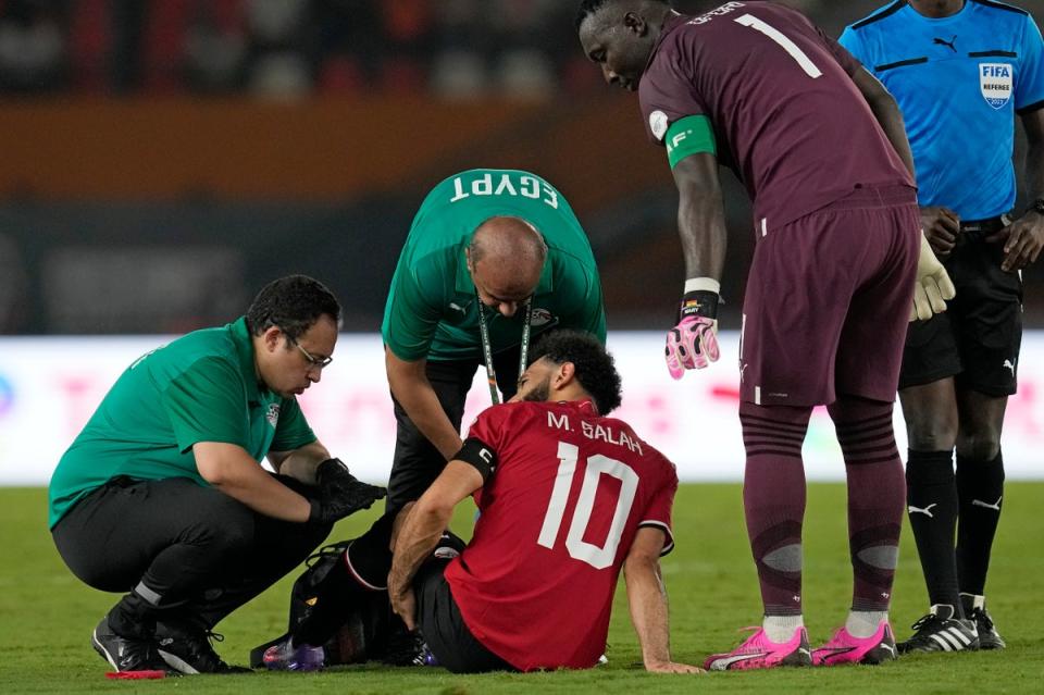 Egypt's Mohamed Salah receives medical treatment (AP)