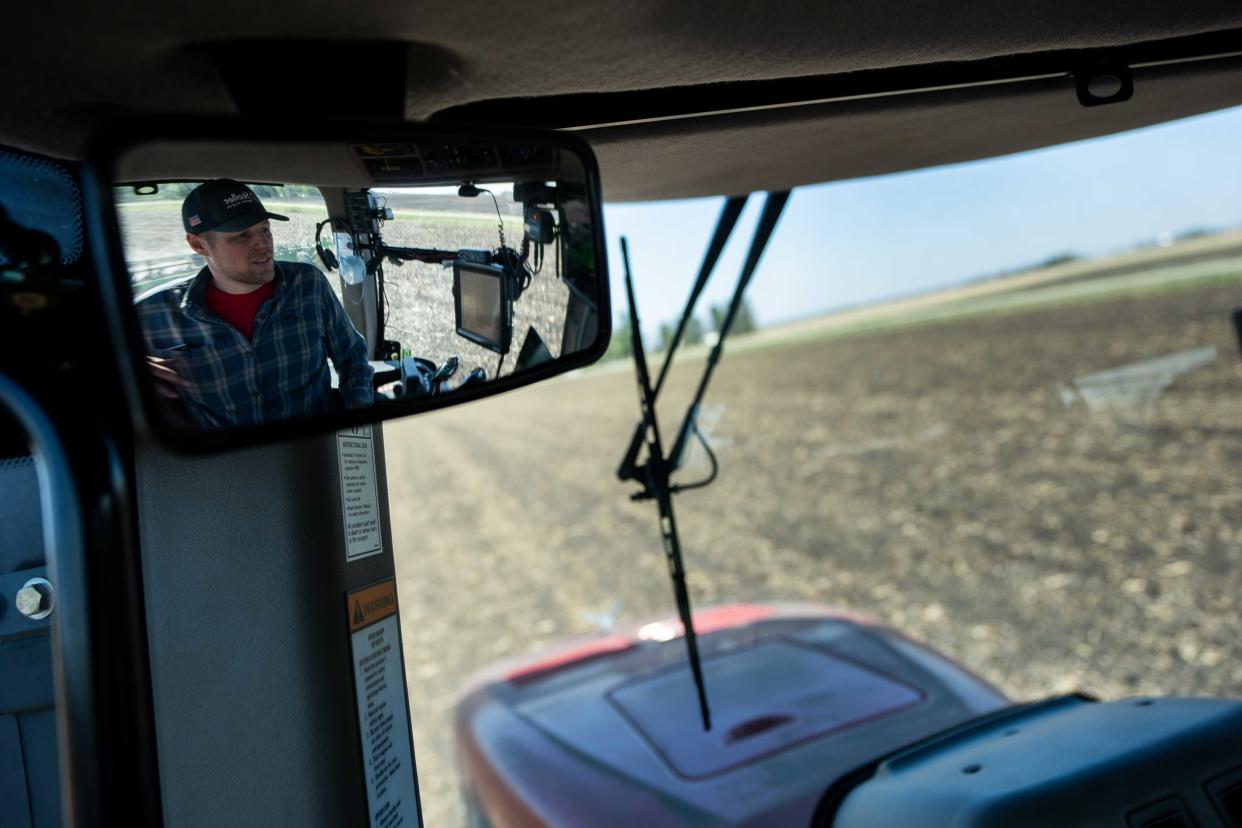 Marcus Heineman guides a tractor as he plants corn Wednesday near Ogden in Boone County.