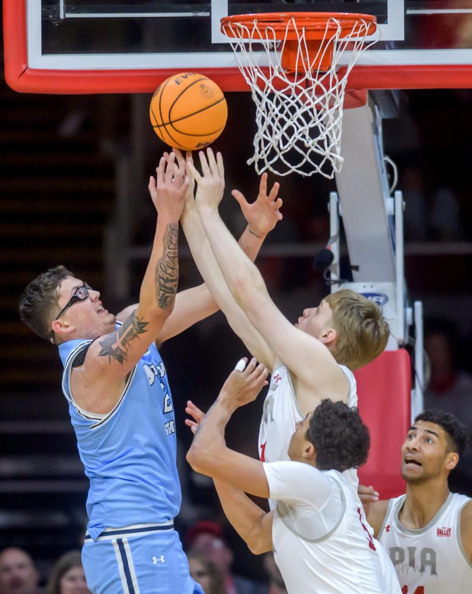 Indiana State's Robbie Avila, left, battles for a rebound with Bradley's Almar Atlason, top right, and Christian Davis, bottom, in the first half of the Braves' MVC basketball home opener Saturday, Dec. 2, 2023 at Carver Arena in Peoria. The Braves fell to the Sycamores 85-77.