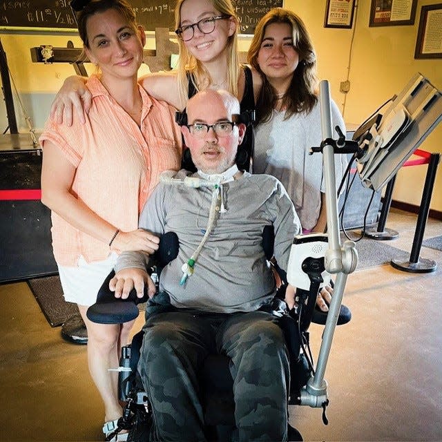 Jay Smith, is surrounded by his wife, Melissa and daughters, Loghan,16, and Payton, 14, as he continues his fight against ALS. A benefit will take place Saturday at the Pine Crest Country Club, Lansdale..