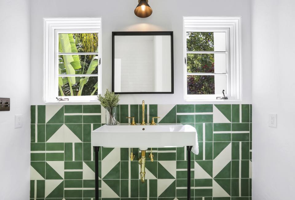 The master bathroom has fun green and white geometric tiles.