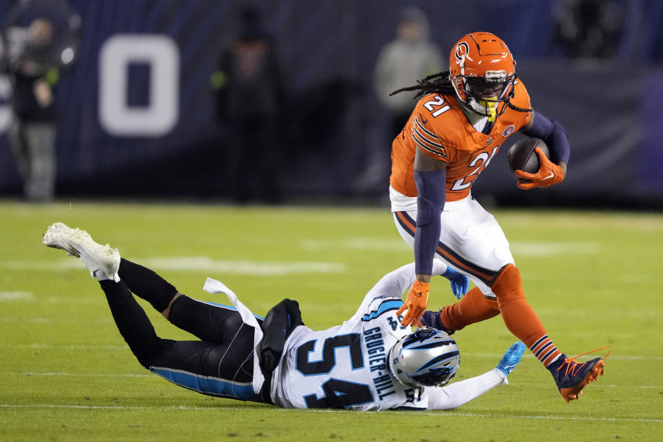Chicago Bears running back D'Onta Foreman (21) is tackled by Carolina Panthers linebacker Kamu Grugier-Hill (54) during the first half of an NFL football game Thursday, Nov. 9, 2023, in Chicago. (AP Photo/Charles Rex Arbogast)