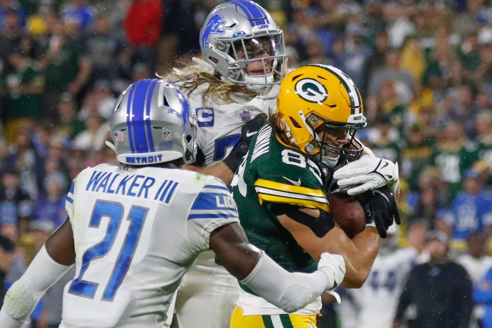 Green Bay Packers' Robert Tonyan catches a touchdown pass between Detroit Lions' Tracy Walker III and Alex Anzalone during the second half of an NFL football game Monday, Sept. 20, 2021, in Green Bay, Wis.