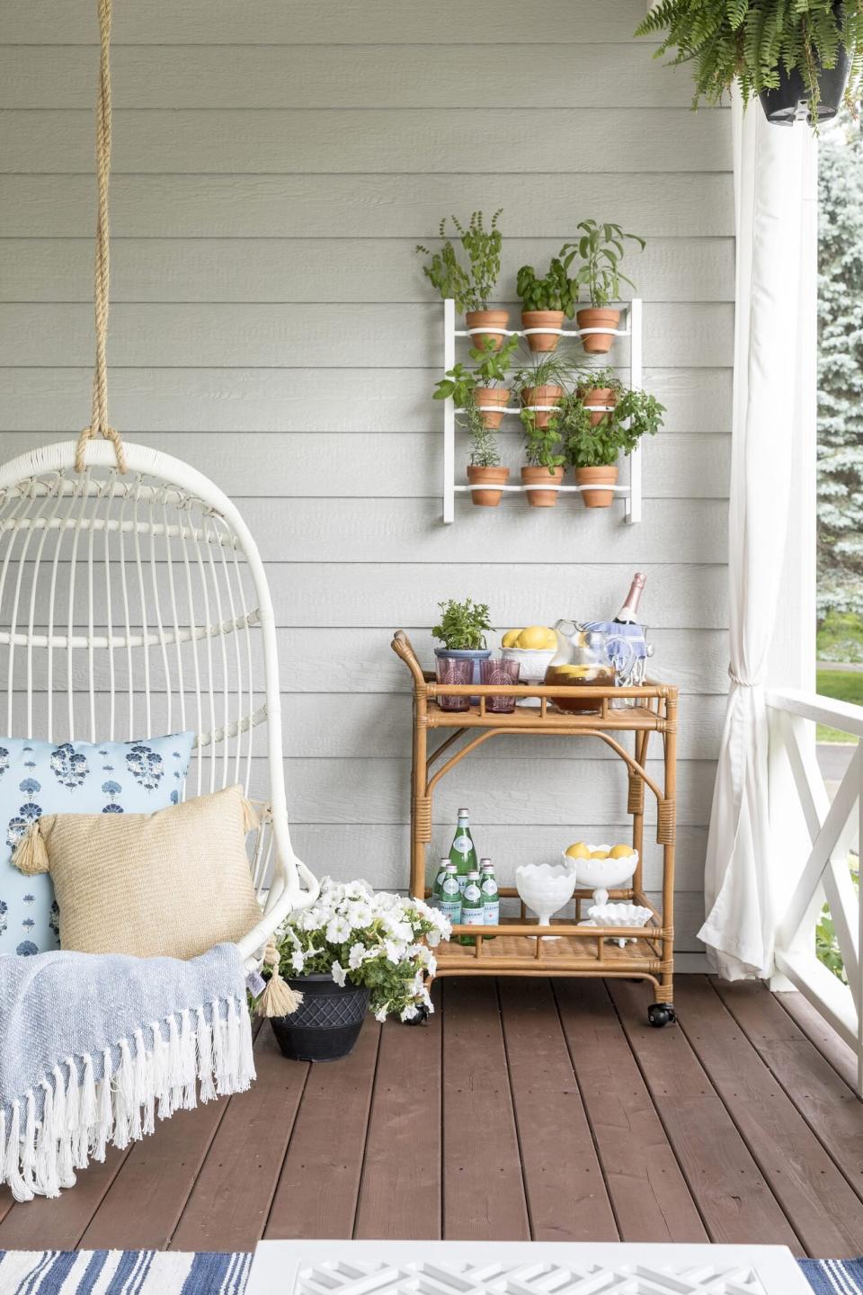 porch with plants and hanging chair