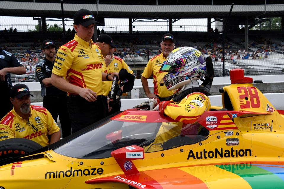 Andretti Autosport driver Romain Grosjean (28) climbs out of his car after his qualifying run Saturday for the 106th running of the Indianapolis 500.