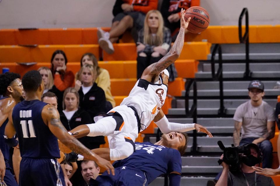 Oklahoma State guard Avery Anderson III (0) fouls Xavier forward Jack Nunge (24) in the second half on Sunday in Stillwater.