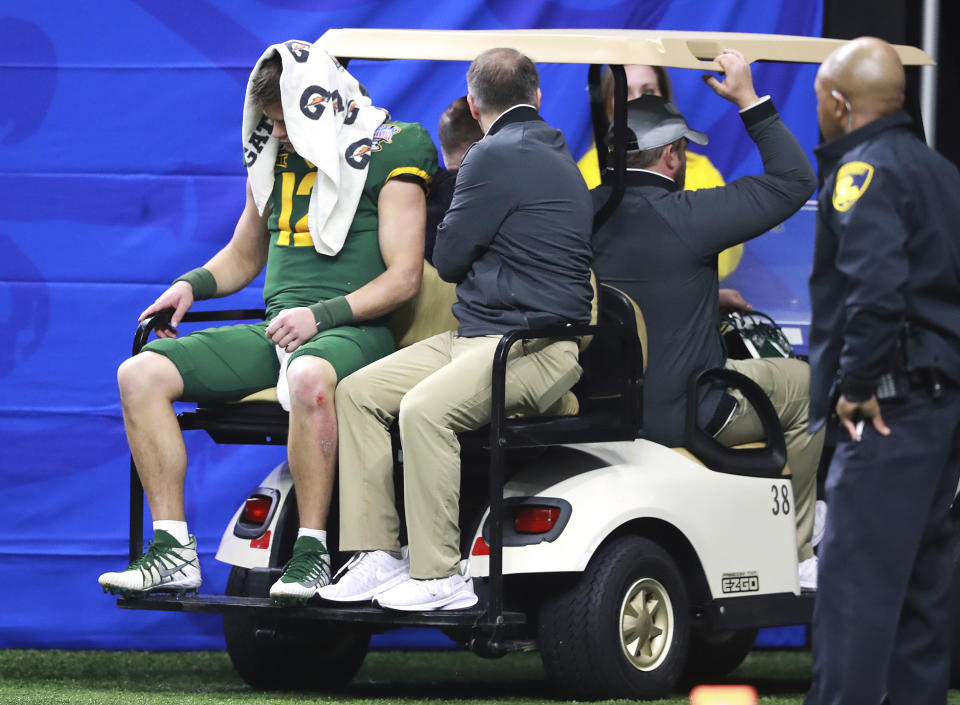 Baylor quarterback Charlie Brewer, left, is carted off the field at the Sugar Bowl NCAA college football game against Georgia, Wednesday, Jan. 1, 2020, in New Orleans. (Curtis Compton/Atlanta Journal-Constitution via AP)