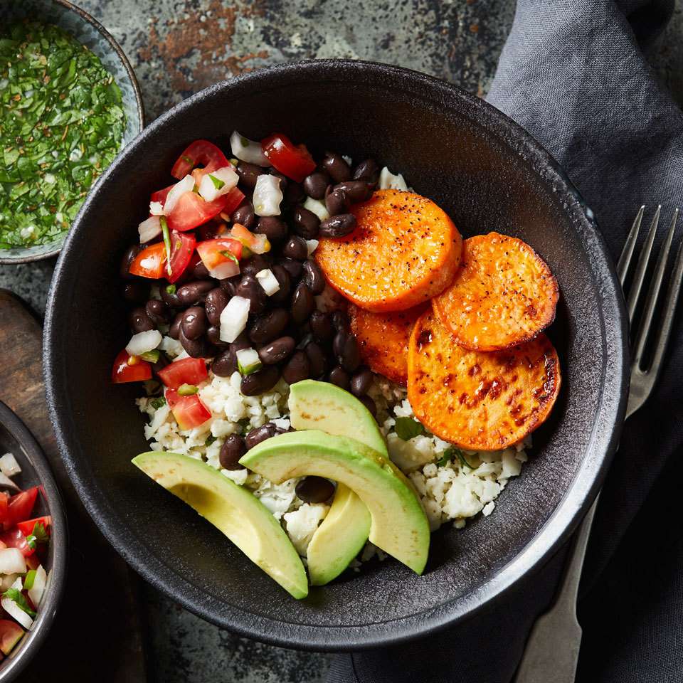 <p>In this riff on a healthy grain bowl recipe, we use cauliflower rice instead of another whole grain like brown rice to cut back on carbs and load up on veggie servings. A simple citrusy drizzle, inspired by Cuban mojo sauce, finishes these vegan rice bowls, perfect for lunch or dinner.</p> <p> <a href="https://www.eatingwell.com/recipe/258449/sweet-potato-cauliflower-rice-bowl/" rel="nofollow noopener" target="_blank" data-ylk="slk:View Recipe;elm:context_link;itc:0;sec:content-canvas" class="link ">View Recipe</a></p>