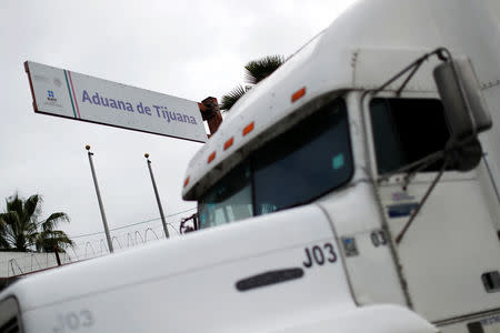 The sign of Tijuana customs is seen as a truck waits in a long queue at border customs control to cross into the U.S, caused by the redeployment of border officers to deal with a surge in migrants, at the Otay border crossing in Tijuana, Mexico April 3, 2019. REUTERS/Carlos Jasso