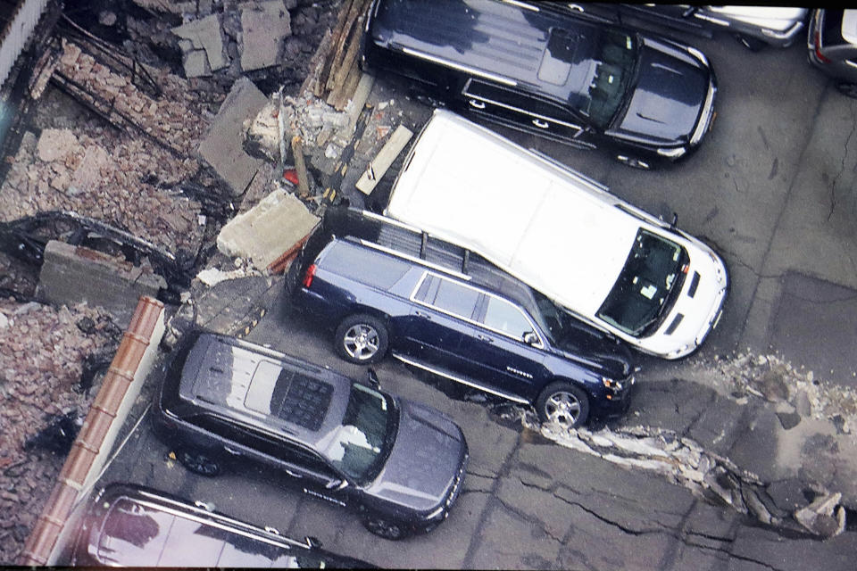 Cars are seen at the partial collapse of a parking garage in the Financial District of New York, Wednesday, April 19, 2023, in New York. The parking garage collapsed Tuesday in lower Manhattan’s Financial District, killing one worker, injuring five and crushing cars as concrete floors fell on top of each other like a stack of pancakes, officials said. (Tom Kaminski/WCBS 880 News via AP)