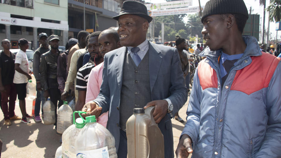 People with containers queuing for petrol in Yaoundé, Cameroon - Tuesday 12 December 2023