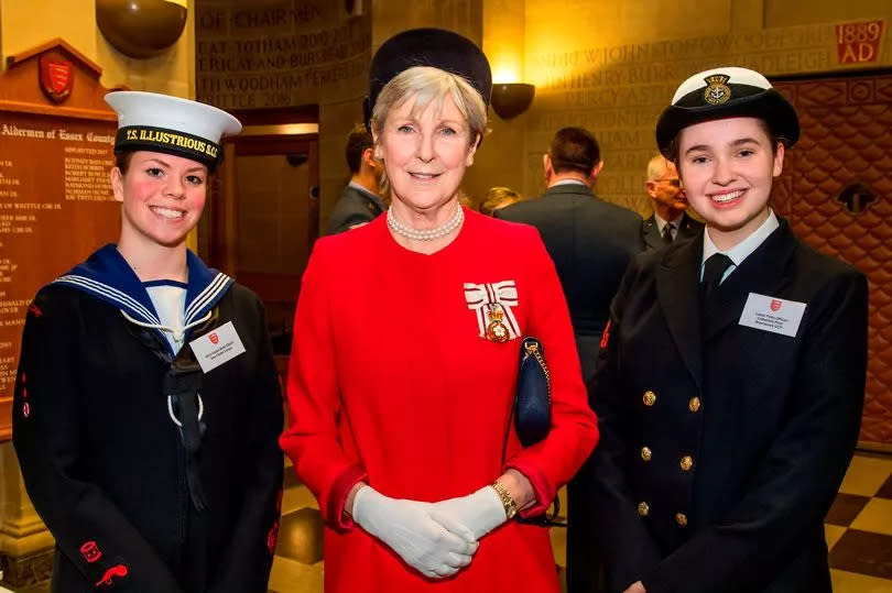 Jennifer Tolhurst at an event, pictured with two Navy cadets