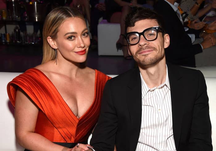 Hilary sits with Matthew at an event