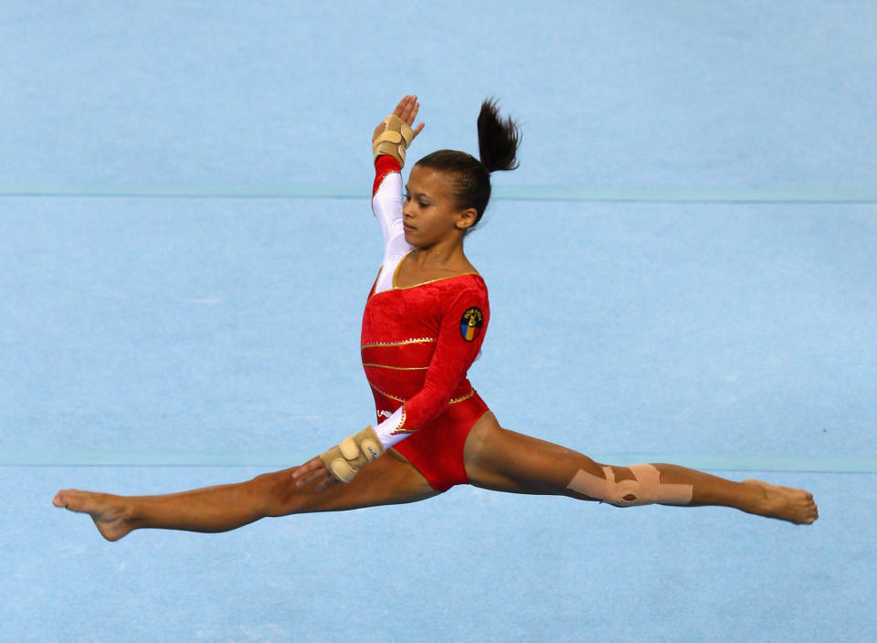 Diana Bulimar, 16, of Romania competes in the Women's floor final on day eight of the Singapore 2010 Youth Olympics at Bishan Sports Hall on August 22, 2010 in Singapore. (Mark Dadswell/Getty Images)