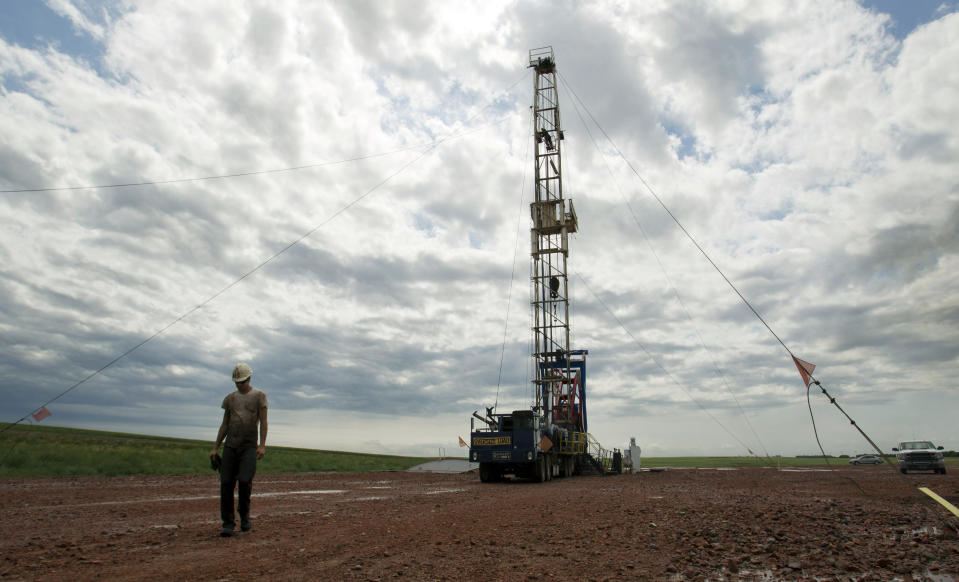 FILE - This Tuesday, July 26, 2011 file photo, shows an oil derrick outside of Williston, N.D. Prosecutors have netted a string of guilty pleas among the suspects in an interstate drug trafficking case that's highlighted the criminal underside of an oil boom sweeping the Northern Plains. (AP Photo/Gregory Bull, File)