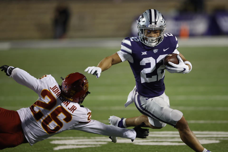 Kansas State running back Deuce Vaughn (22) gets past Iowa State defensive back Anthony Johnson Jr. (26) for a first down during the first quarter of an NCAA football game on Saturday, Oct. 16, 2021, in Manhattan, Kan. (AP Photo/Colin E. Braley)