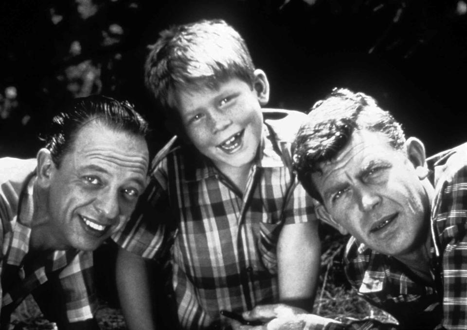 FILE- This undated file image originally released by Viacom shows cast members from "The Andy Griffith Show," from left, Don Knotts as Deputy Barney Fife, Ron Howard as Opie Taylor and Andy Griffith as Sheriff Andy Taylor. Tourism in Mount Airy is up since Andy Griffith died July 3, with about 10,400 people visiting the Andy Griffith Museum in July, almost double the 5,400 who visited in July 2011. (AP Photo/Viacom, file)