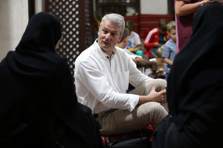 Tourists talk to an Emirati woman volunteer to learn about Ramadan and Emirati culture during the Muslim holy fasting month of Ramadan, at the Sheikh Mohammed Centre for Cultural Understanding (SMCCU) in Dubai, UAE May 17, 2019. REUTERS/Satish Kumar