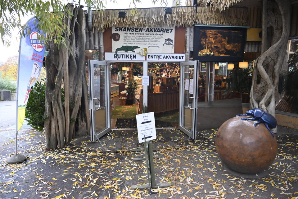 The Skansen Aquarium's entrance, part of the zoo on Djurgarden island, where a deadly snake escaped on Saturday via a light fixture in the ceiling of its glass enclosure, in Stockholm, Sweden, Monday Oct. 24, 2022. A venomous king cobra which escaped from its home in a Swedish zoo six days ago has been located inside the building where its terrarium is located but has not yet been recaptured, the park said Friday, Oct. 28, 2022. (Henrik Montgomery/TT News Agency via AP)