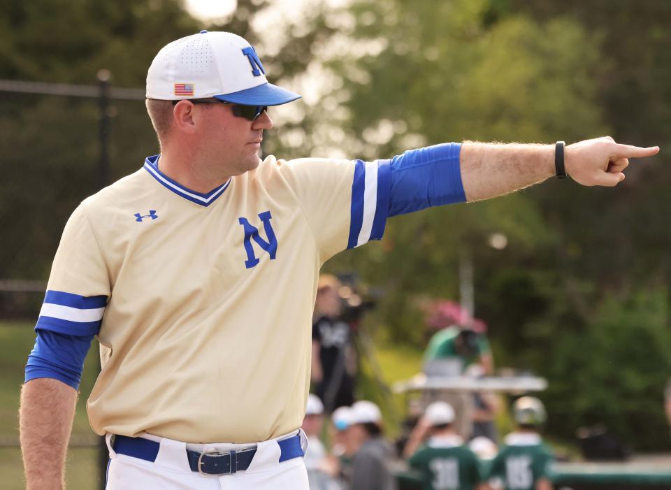 Norwell High School varsity baseball coach Barrett Jacobs, in his first season after taking over the reins from his father, Tom, gestures during a game versus Abington on Wednesday, May 24, 2023.