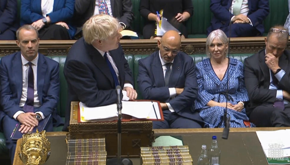 In this grab taken from video from the House of Commons, Britain's Prime Minister Boris Johnson speaks during Prime Minister's Questions in the House of Commons, London, Wednesday July 6, 2022. Johnson is fighting for his political future Wednesday, as two of his top Cabinet ministers walked out of their jobs and a string of more junior ministers resigned after months of political chaos. (House of Commons/PA via AP)