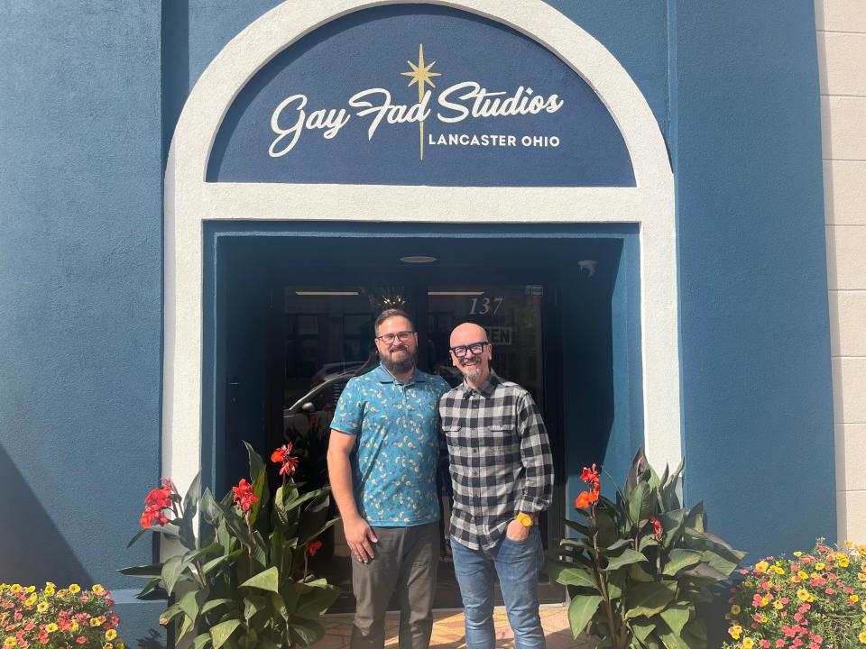 The owners of Gay Fad Studios, David and Jason Annecy, outside of their storefront.