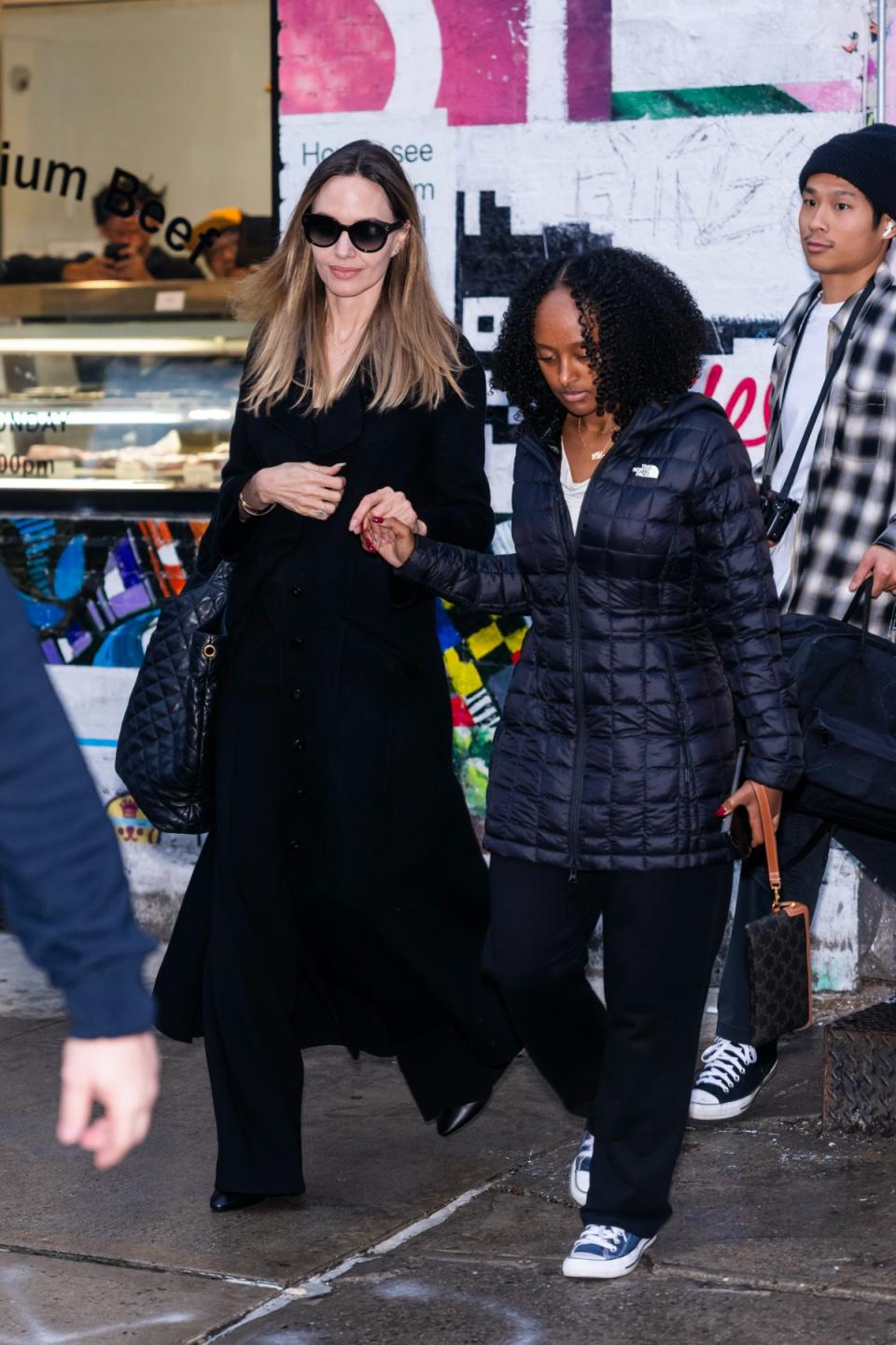 Angelina Jolie, Zahara Jolie-Pitt, Atelier Jolie, Converse, sneakers, womens sneakers, blue sneakers, canvas sneakers, lace up sneakers, high top sneakers, North Face, North Face coat, puffer coat, black coat, winter coat, Celine, pouch, canvas pouch, shoes, footwear, celebrity style 