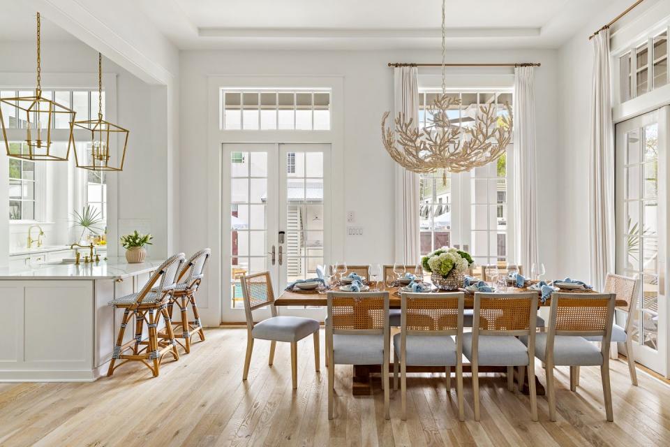 a dining room with a chandelier and chairs