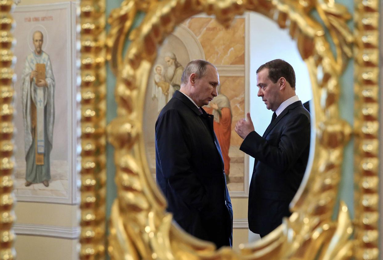 Russian president Vladimir Putin and Dmitry Medvedev (AFP via Getty Images)