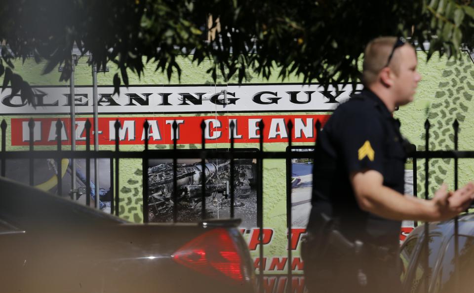 A police officer walks by a hazardous material clean-up truck at the apartment unit where a man diagnosed with the Ebola virus was staying in Dallas, Texas, October 3, 2014. (REUTERS/Jim Young)