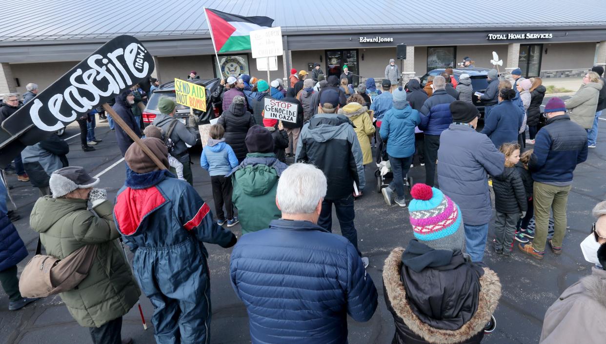 People gather Wednesday, March 27, 2024, outside the offices of Indiana U.S. Rep. Rudy Yakym, R-2nd, at a prayer vigil for peace by the group Mennonite Action calling on the Congressman to work for a ceasefire in Gaza.