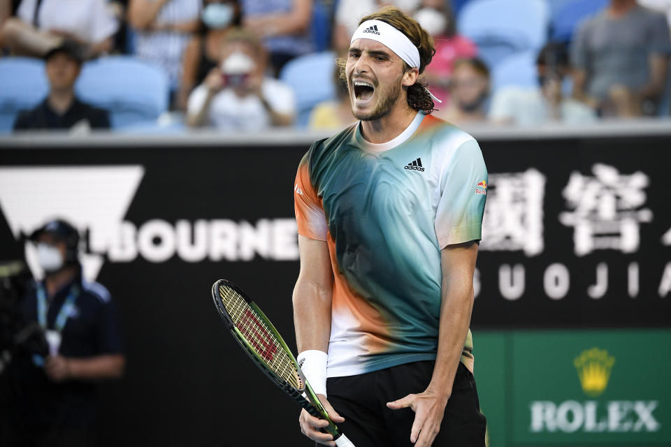 Stefanos Tsitsipas of Greece reacts after losing a point to Sebastian Baez of Argentina during their second round match at the Australian Open tennis championships in Melbourne, Australia, Thursday, Jan. 20, 2022. (AP Photo/Andy Brownbill)