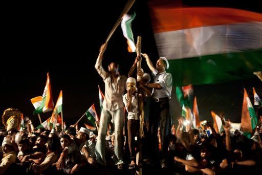 Supporters of anti-corruption activist Anna Hazare celebrate at the Ram Lila grounds in New Delhi, on August 27, 2011. On Saturday, parliament agreed in principle that all state and central government officials would come under proposed anti-graft legislation being drafted by lawmakers and to a new citizens' charter promoting transparency