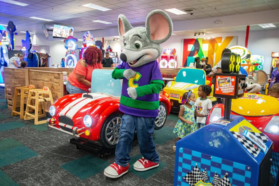 Chuck E. Cheese greets children during a grand reopening event on Wednesday, Aug. 24, 2022, in Rockford.