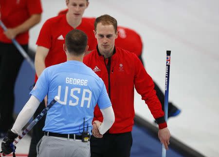 Curling - Pyeongchang 2018 Winter Olympics - Men's Round Robin - Britain v U.S. - Gangneung Curling Center - Gangneung, South Korea - February 21, 2018 - Kyle Smith of Britain shakes hands with Tyler George of the U.S. after losing to the U.S. REUTERS/Phil Noble