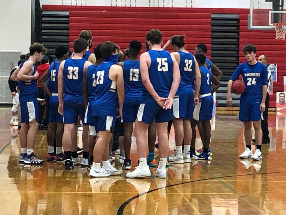 The Manchester boys basketball teams huddles up during a timeout. Eventually, the Hawks defeated Jackson Liberty, 67-34, on Jan. 26, 2021.