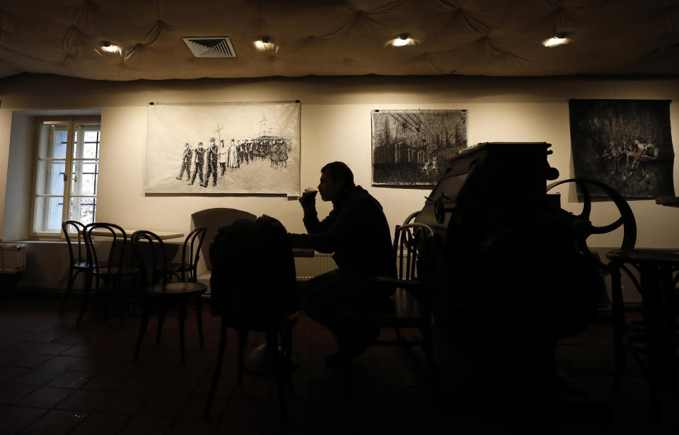 Man enjoys a beer at a bar in Prague, Czech Republic, Thursday, Dec. 3, 2020. A sign of normalcy has returned to the Czech Republic ahead of the Christmas period after the government eased some of its most restrictive measures imposed to contain the recent massive surge of coronavirus infections. On Thursday all stores, shopping malls, restaurants, bars and hotels were allowed to reopen. (AP Photo/Petr David Josek)