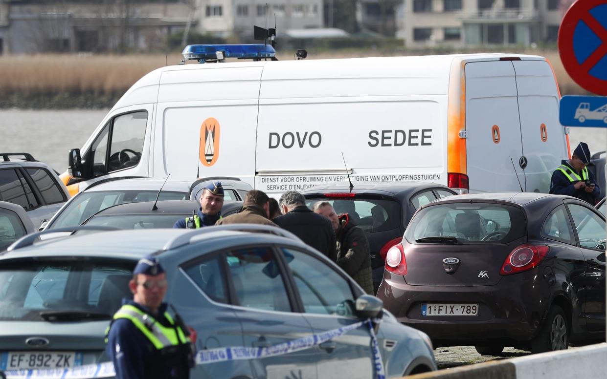 Police officers and the Sedee-Dovo, the Belgian military's bomb disposal squad, near the scene of the arrest in Antwerp  -  VIRGINIE LEFOUR/ AFP/Getty Images