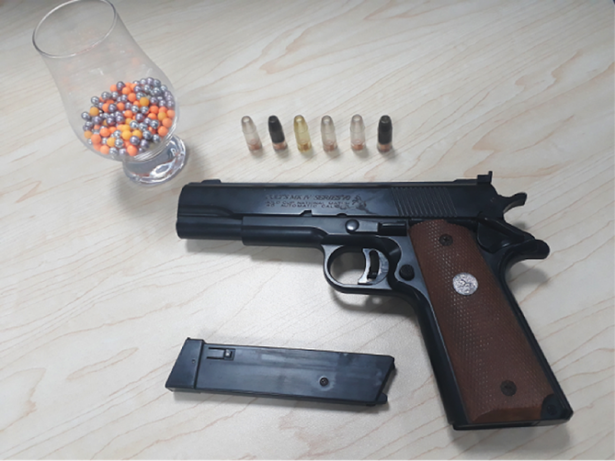 File photo: An airsoft pistol and pellets (Singapore Police Force)